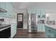 Stainless steel refrigerator in light blue kitchen at 130 Johnson Dairy Rd, Rockwell, NC 28138