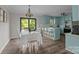 Open concept dining and kitchen with unique light blue cabinets and eat-in island at 130 Johnson Dairy Rd, Rockwell, NC 28138