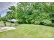 Landscaped backyard with a patio, gray umbrella, and a spacious grassy area perfect for outdoor activities at 1532 Andora Dr, Rock Hill, SC 29732