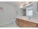 This bathroom has a double sink vanity with wood cabinets, a toilet, a large mirror, and neutral colored flooring at 1532 Andora Dr, Rock Hill, SC 29732