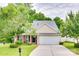 Charming single-Gathering home featuring a well-maintained lawn, a two-car garage, and mature trees at 1532 Andora Dr, Rock Hill, SC 29732