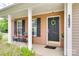 Inviting brick front porch with black shutters, a dark-colored front door, and decorative accents at 1532 Andora Dr, Rock Hill, SC 29732