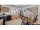 Open kitchen with wooden cabinets, tile flooring, black appliances, and a view of the adjacent living area at 1532 Andora Dr, Rock Hill, SC 29732