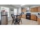 Bright eat-in kitchen with wooden cabinets, black appliances, tile flooring, and casual dining area at 1532 Andora Dr, Rock Hill, SC 29732