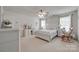 A bright main bedroom features a ceiling fan, two windows, and a white wood bed frame with desk and rocking chair at 1532 Andora Dr, Rock Hill, SC 29732