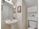 This powder room features a pedestal sink, toilet, storage cabinet and decorated with framed artwork at 1532 Andora Dr, Rock Hill, SC 29732