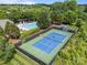 Aerial view of community pool and tennis court surrounded by lush greenery and neighborhood amenities at 15913 Trenton Place Rd, Huntersville, NC 28078