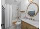 Cozy bathroom with a combined tub and shower, featuring marble accents and a stylish vanity with ample storage at 15913 Trenton Place Rd, Huntersville, NC 28078