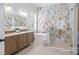 Luxurious bathroom featuring a soaking tub, walk-in shower, marble accent wall, double vanity, and elegant fixtures at 15913 Trenton Place Rd, Huntersville, NC 28078