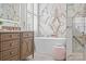Elegant bathroom featuring a soaking tub, marble accent wall, a stylish vanity with modern fixtures, and bright natural light at 15913 Trenton Place Rd, Huntersville, NC 28078