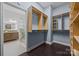 Spacious walk-in closet with custom shelving and ample storage, adjacent to a modern bathroom with marble accents at 15913 Trenton Place Rd, Huntersville, NC 28078