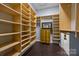 Well-organized walk-in closet featuring custom shelving, drawers, and ample storage space for clothing and accessories at 15913 Trenton Place Rd, Huntersville, NC 28078