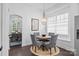 Cozy dining area with a round table, chandelier, and view of another dining space at 15913 Trenton Place Rd, Huntersville, NC 28078