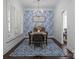 Beautiful dining room boasts unique wallpaper, wood floors, and modern chandelier at 15913 Trenton Place Rd, Huntersville, NC 28078