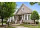 Charming two-story home with covered porch, white columns, beautifully landscaped yard and sidewalk at 15913 Trenton Place Rd, Huntersville, NC 28078