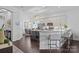 Bright, open kitchen with island, bar seating, stainless steel appliances, and modern lighting fixtures at 15913 Trenton Place Rd, Huntersville, NC 28078