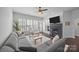Spacious living room with fireplace, large windows, modern ceiling fan and comfortable seating at 15913 Trenton Place Rd, Huntersville, NC 28078