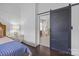 Stylish main bedroom featuring an ensuite bathroom with marble accents and a sliding barn door at 15913 Trenton Place Rd, Huntersville, NC 28078
