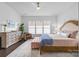 Bright and spacious main bedroom with a large window and comfortable furnishings at 15913 Trenton Place Rd, Huntersville, NC 28078
