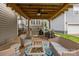Inviting outdoor patio features a ceiling fan, wicker furniture, and grilling area for relaxing and entertaining at 15913 Trenton Place Rd, Huntersville, NC 28078