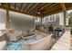 Inviting outdoor patio features a ceiling fan, wicker furniture, and grilling area for relaxing and entertaining at 15913 Trenton Place Rd, Huntersville, NC 28078