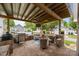 This lovely outdoor patio comes complete with a mounted TV, ceiling fan, and grilling area at 15913 Trenton Place Rd, Huntersville, NC 28078