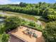 Aerial view of the community playground and adjacent walking trail and lake with mature trees in the background at 15913 Trenton Place Rd, Huntersville, NC 28078