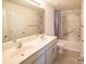 Well-lit bathroom with double sink vanity, marble-look shower and tub, and neutral color palette at 1600 Gaston Mountain Dr, Dallas, NC 28034