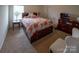 Comfortable bedroom featuring a wooden bedframe with built in storage and patterned bedding at 1600 Gaston Mountain Dr, Dallas, NC 28034