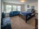 Bedroom with a comfy blue couch, and a bed with a blue blanket, and carpet flooring at 1600 Gaston Mountain Dr, Dallas, NC 28034