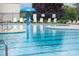 Well-maintained community pool featuring clear water, lounge chairs, and a splash umbrella at 1600 Gaston Mountain Dr, Dallas, NC 28034