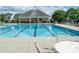Inviting community pool with surrounding lounge chairs and a covered pool house at 1600 Gaston Mountain Dr, Dallas, NC 28034