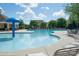 Relaxing community pool with lounge chairs and ample seating surrounded by lush greenery at 1600 Gaston Mountain Dr, Dallas, NC 28034