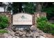 Spencer Mountain Village entrance sign with stacked stone pillars and a small decorative waterfall feature at 1600 Gaston Mountain Dr, Dallas, NC 28034