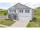 Charming two-story home featuring stone accents, blue shutters, and a well-manicured lawn at 1600 Gaston Mountain Dr, Dallas, NC 28034