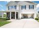 Two-story home featuring a two-car garage and inviting front porch with stone accents at 1600 Gaston Mountain Dr, Dallas, NC 28034