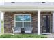 Inviting front porch with stone accents and comfortable seating for relaxing outdoors at 1600 Gaston Mountain Dr, Dallas, NC 28034