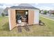 Shed with open doors showing lawn care equipment stored inside on a well-maintained lawn at 1600 Gaston Mountain Dr, Dallas, NC 28034