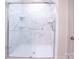 A glass-enclosed shower with white marble-style tile and built-in shelves at 1600 Gaston Mountain Dr, Dallas, NC 28034