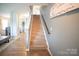 A carpeted staircase with wooden handrail leads to the upper level of this home at 1600 Gaston Mountain Dr, Dallas, NC 28034