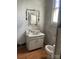 Bathroom in need of renovations showcasing a sink with covered fixtures, toilet, and partially covered mirror at 169 Saluda St, Chester, SC 29706