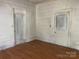A bedroom featuring hardwood floors, white trim, and a closet awaiting finishing touches and customization at 169 Saluda St, Chester, SC 29706