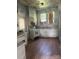 Shows a kitchen in need of renovation with outdated appliances and cabinetry on wood floors at 169 Saluda St, Chester, SC 29706