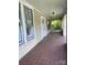 Tiled front porch features an open-air design with white trim, providing a great space for outdoor relaxation at 169 Saluda St, Chester, SC 29706