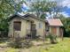 Property's exterior needing refurbishment with some boarded windows and a partially metal roof at 169 Saluda St, Chester, SC 29706