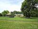 Fenced backyard offers a view of the property, bordered by mature trees at 1922 Salem Church Rd, Lincolnton, NC 28092