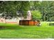 Backyard features an above-ground pool surrounded by lush green grass and mature trees at 1922 Salem Church Rd, Lincolnton, NC 28092