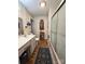 Well-lit bathroom showcasing a vanity, a toilet, and a shower with a glass door at 1922 Salem Church Rd, Lincolnton, NC 28092