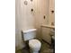 Modest bathroom features a standard toilet, dated wallpaper, and functional fixtures at 1922 Salem Church Rd, Lincolnton, NC 28092