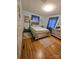 Comfortable bedroom featuring a bed, large dresser, and hardwood flooring at 1922 Salem Church Rd, Lincolnton, NC 28092